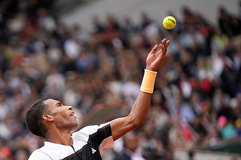 Felix Auger-Aliassime serves against Spain's Carlos Alcaraz